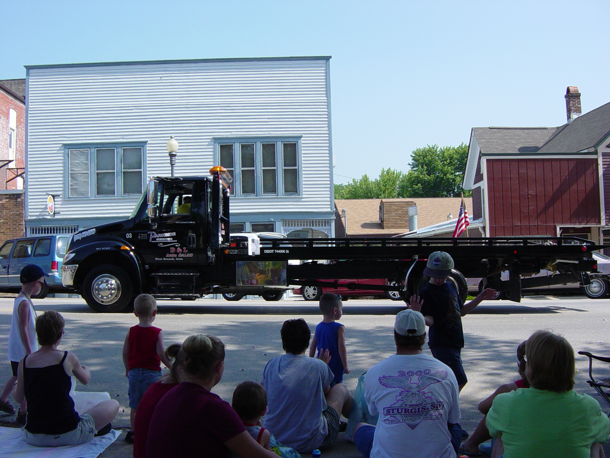 Local auto and towing company, showing off their new trailer.  They moved our shed.  Yay!